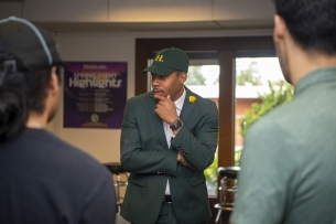 Mitch Mitchell meets with two students.